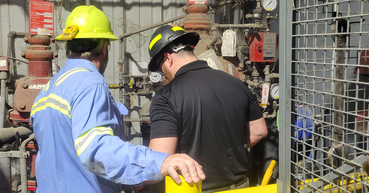 worker inspecting fire-related equipment